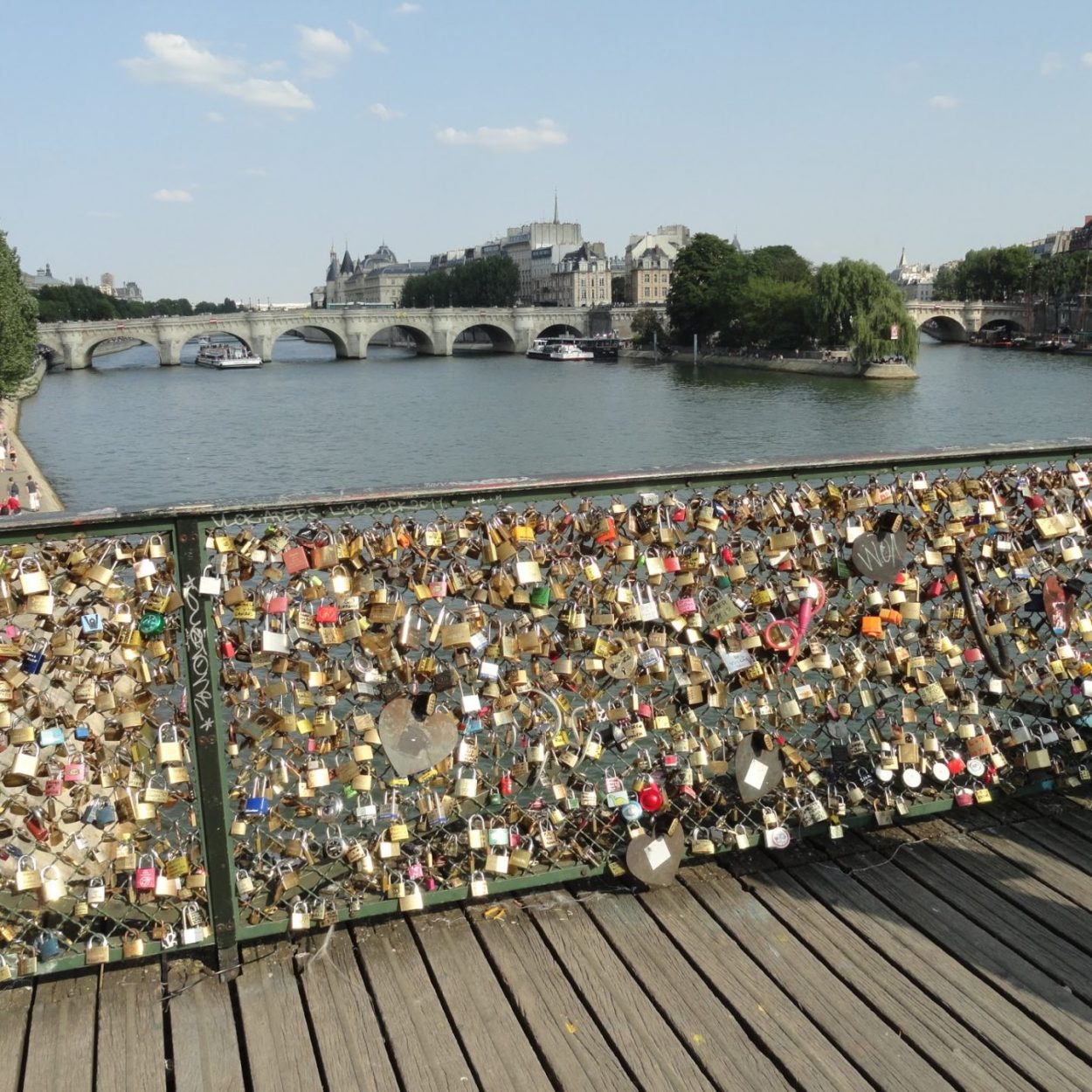 The Pont des Arts, a pedestrian bridge on the river Seine. Visitors attach padlocks to its railing and throw the keys into the Seine as a gesture of love.